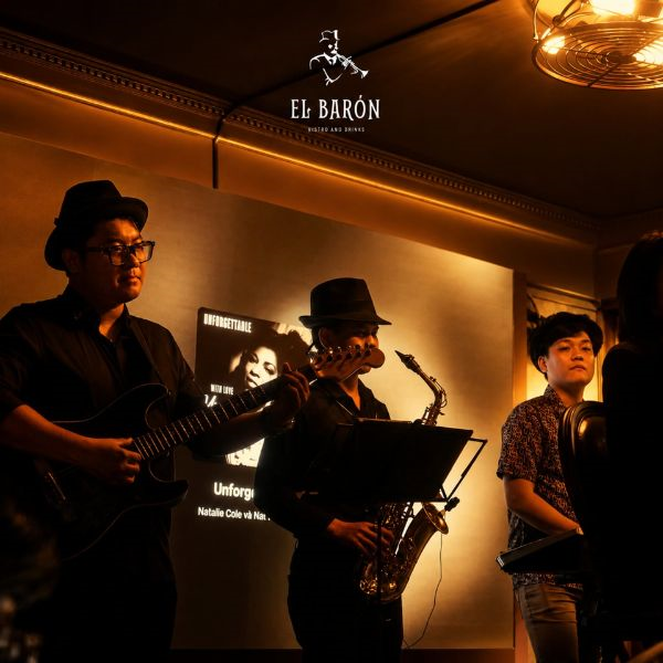 Live jazz band performing with saxophone and guitar at El Baron Saigon Lounge
