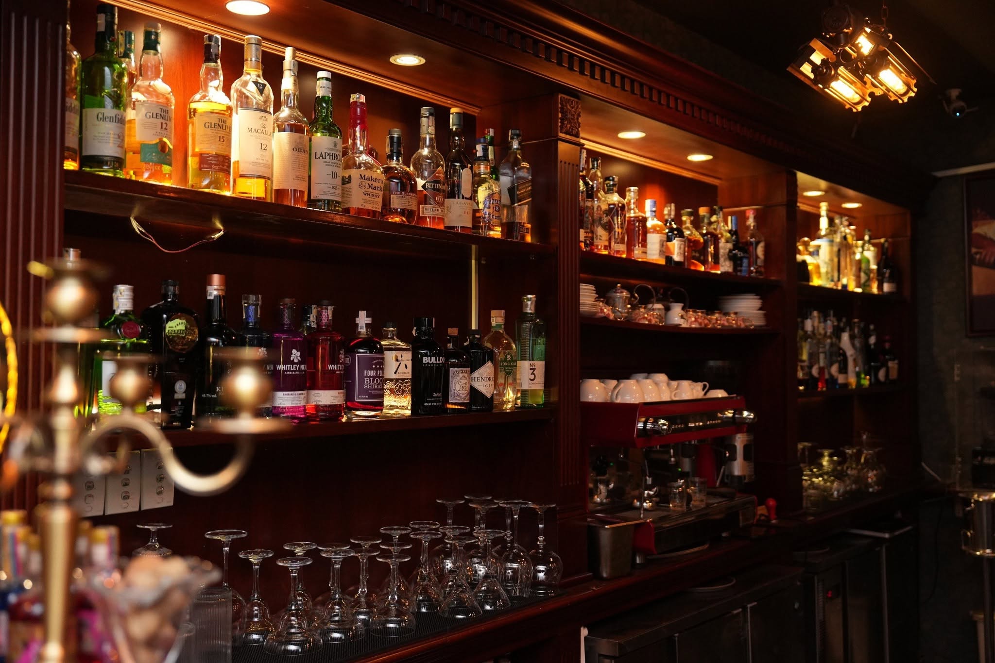 Mixologist crafting a signature cocktail with clear ice in District 7